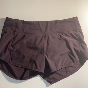 Burgundy/maroon Lululemon speed up shorts.